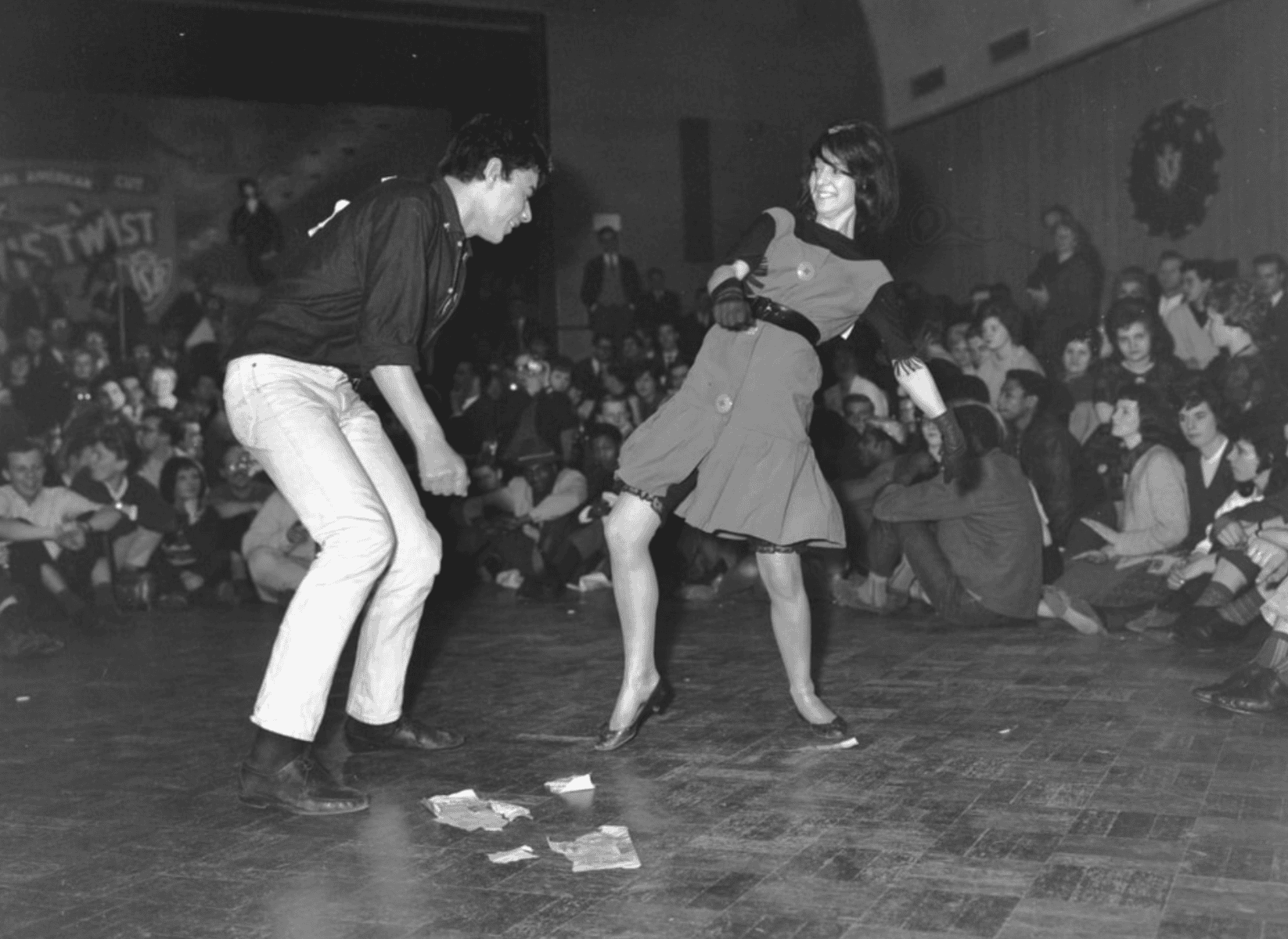 Vintage shot of a couple doing the twist at a sock hop