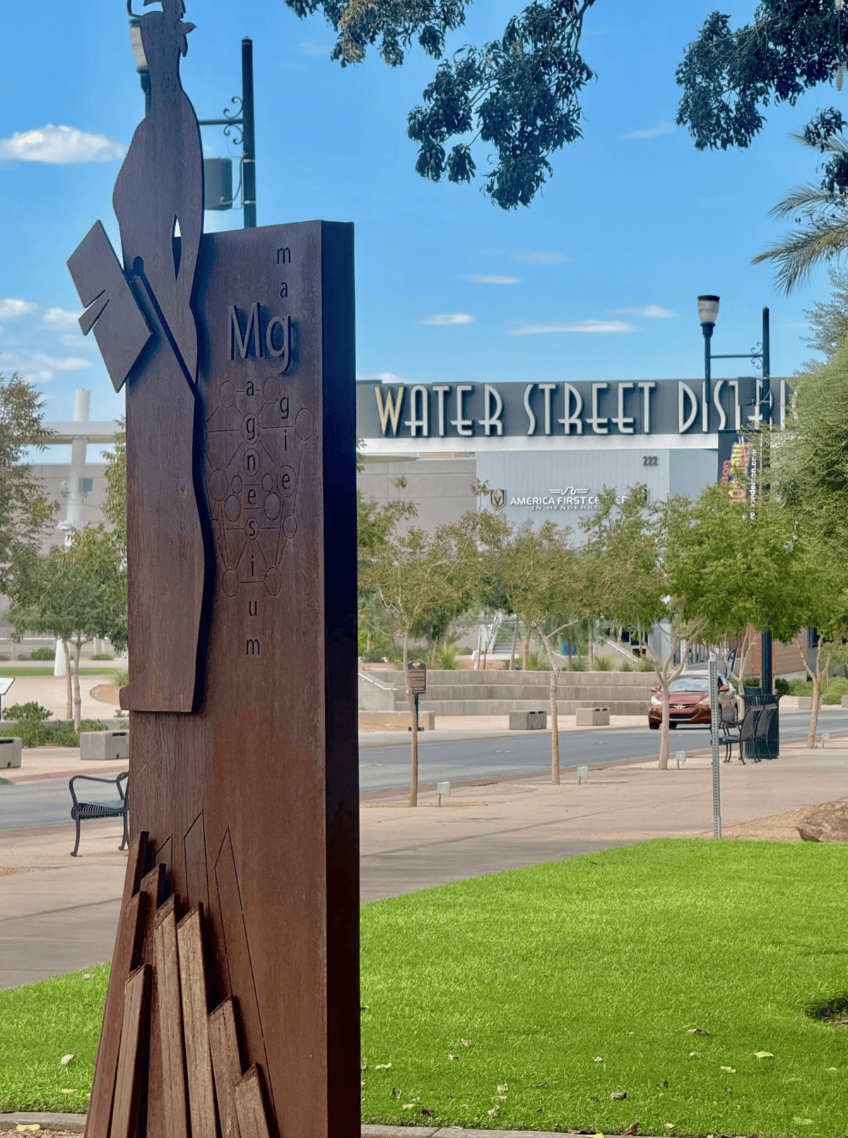 Sculpture with Water Street District sign in the background