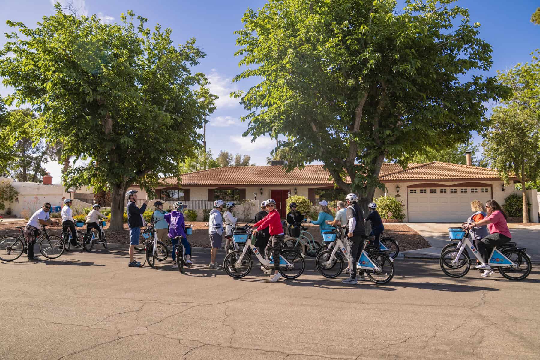 Paradise Crest Bike Tour group in front of a home